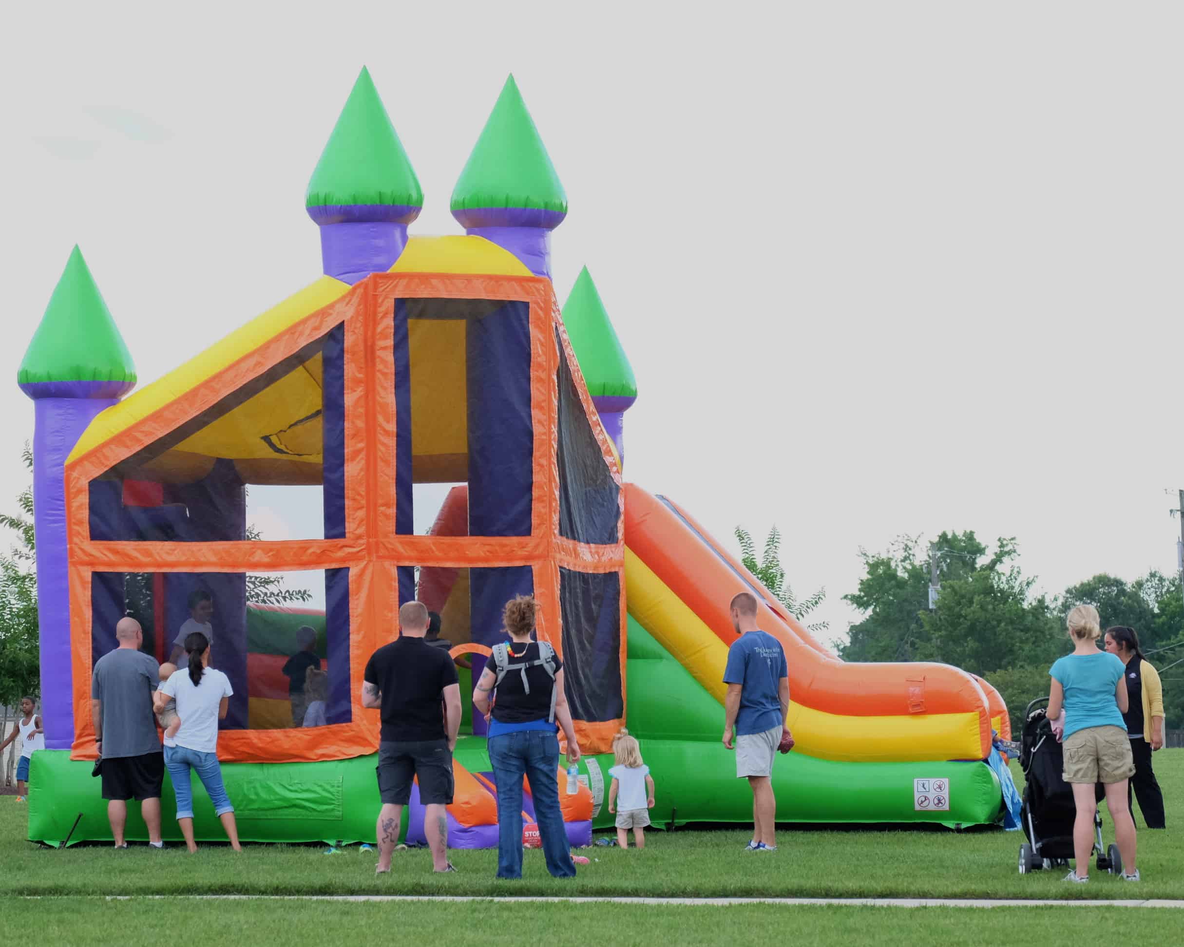 Family enjoying an inflatable at a celebration